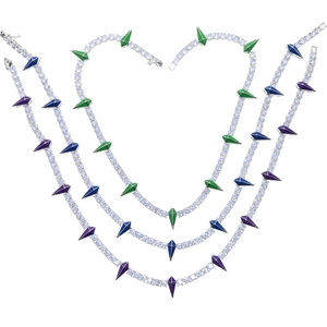Detail of 5mm silver tennis chain with green, blue, and purple crystal spike pendants