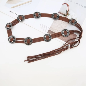 Close-up of Bohemian brown suede waist chain with vintage silver buckles and long fringe