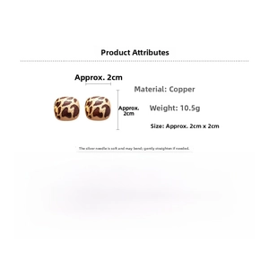 Detailed view of leopard print square earrings with copper base and silver needle studs