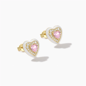 Macro shot of 925 sterling silver heart earrings with pink zircon and white enamel