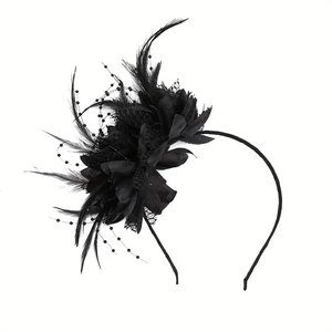 Detailed view of black feather flower headpiece with mesh veil and beaded accents