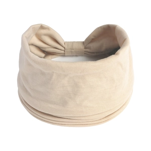 Dettaglio della trama a pieghe e del fiocco sul retro della fascia per capelli beige