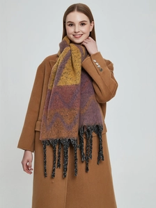 Close-up of geometric pattern and black fringe on faux mohair winter shawl scarf