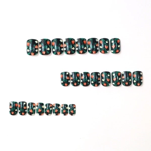 Short square press-on nails set with red strawberry and white flower patterns