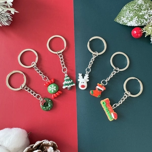 Set of six Christmas keychains with Santa and reindeer on festive red and green background