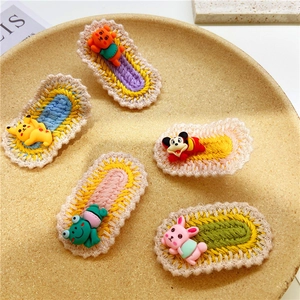Detailed view of 5-piece handmade knit hair clips with colorful cartoon decorations