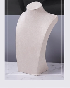 Macro detail of beige fabric texture on a portrait bust necklace display stand