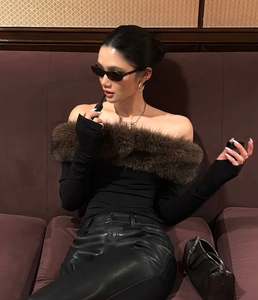 Elegant black off-shoulder top with a luxurious brown faux fur collar and long sleeves