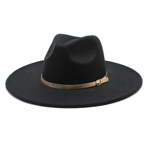 Detail of black wool fedora hat featuring a tan leather strap and gold metal buckle