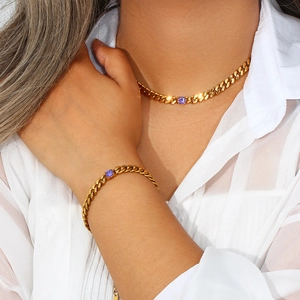 Fashionable gold Cuban chain set with purple round zircon worn by a model