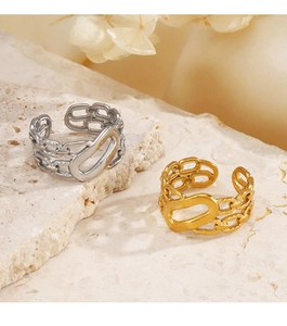 Detail of 18K gold and silver plated chain link rings on a natural stone base