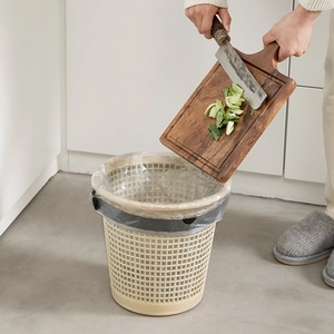 Beige mesh plastic waste basket with fixing ring used for kitchen food waste collection