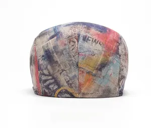 Rear view of tie-dye beret showing street-art graffiti print and stitching details
