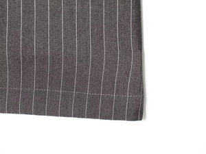 Detailed view of dark grey pinstripe fabric texture and professional stitching finish