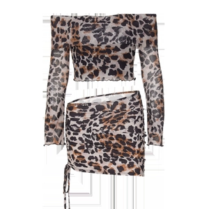 Detail of leopard print fabric with side drawstring design on slimming mini skirt