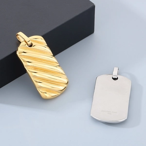 Macro shot of gold and silver square wave texture pendants made of 316L stainless steel