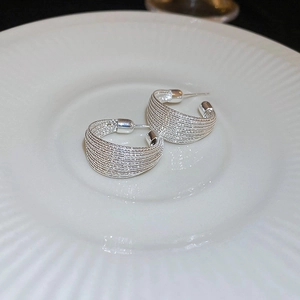 Silver textured C-shaped hoop earrings featuring a minimalist layered wire design