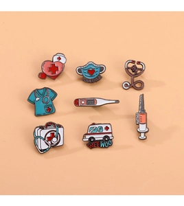 Flat lay detail of 9 medical themed enamel pins including stethoscope and ambulance icons