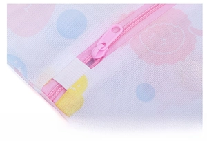 Close-up of pink smooth zipper and lion print mesh on this laundry washing bag