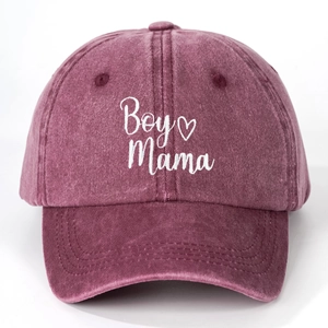Close-up of white Boy Mama embroidery with heart on vintage washed cotton baseball cap