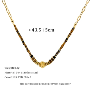 Detail of beaded and 18K gold-plated chain necklace with faceted Tiger Eye stone