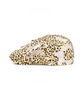 Side view detail of leopard print newsboy cap with white lace mesh overlay for women