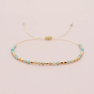 Handmade bohemian beaded bracelet with blue natural stones and adjustable gold spacers