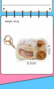 Close-up detail of a car game machine keychain with a cute cartoon bear and dimensions