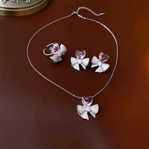 Ensemble détaillé de collier, boucles d'oreilles et bague avec cœurs roses et nœuds