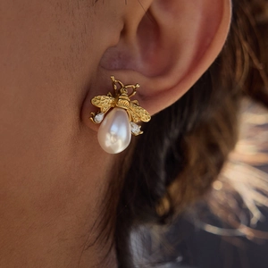 Elegant bee earrings featuring gold wings with zircons and large white teardrop pearls