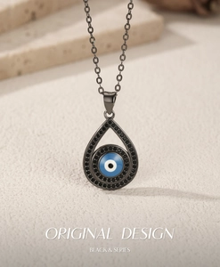 Detailed macro view of an S925 silver Evil Eye pendant with blue iris and black stones