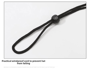 Detail of adjustable black woven chin strap with a round plastic cord lock for sun hats