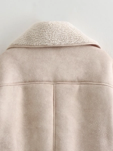 Detail view of beige faux suede and soft white fleece collar with premium stitching