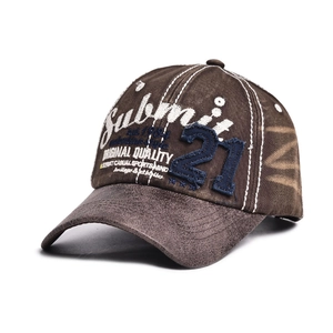 Close-up of vintage brown washed cotton baseball cap with detailed white script embroidery