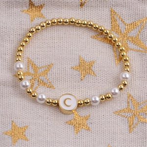 Gold plated bead and pearl bracelet featuring a circular enamel letter C pendant charm