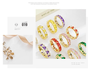 Macro shot of triangle-cut colorful cubic zirconia ring with gold plating