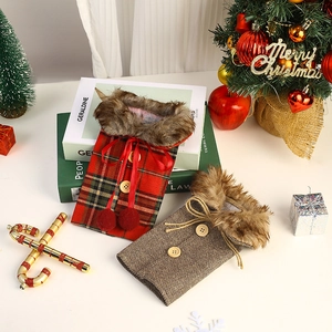 Macro detail of Christmas burlap wine bottle covers with faux fur collars and wooden buttons