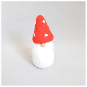 Detailed view of handmade wool felt Christmas gnome ornament with red polka dot hat