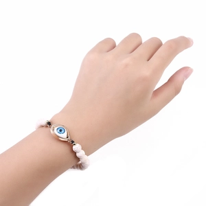 Adjustable white turquoise beaded bracelet with golden evil eye charm for women