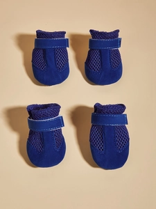 Detail view of breathable royal blue mesh dog shoes with adjustable velcro straps