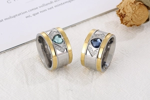 Detail of wide two-tone ring featuring blue heart-shaped crystals and small diamonds
