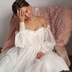 Elegant white off-shoulder polka dot mesh dress with puff sleeves and long flowing skirt