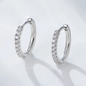 Detail shot of s925 sterling silver huggie earrings with micro-paved zirconia gems