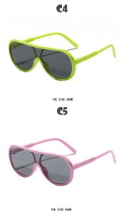 Close-up of oversized one-piece sunglasses in neon green and pink with UV lenses