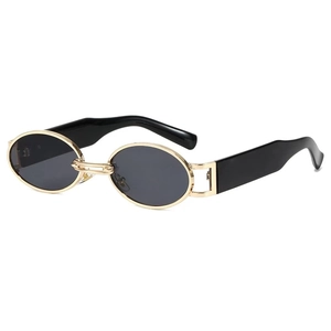 Detail view of retro oval sunglasses with gold metal frame and black temple arms