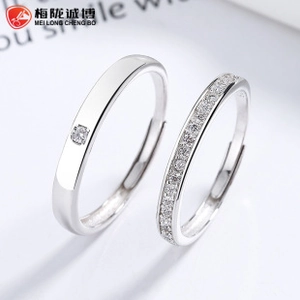Detailed macro view of 925 sterling silver couple rings with polished finish and diamond inlay