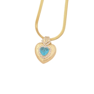 Golden heart necklace with blue gemstone and feather texture on a flat snake chain