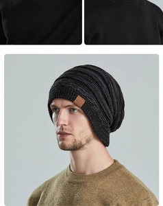 Detail view of the ribbed knit beanie texture and embossed leather logo patch on the side
