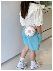 Detailed view of white donut-themed girls crossbody bag featuring Hello text print