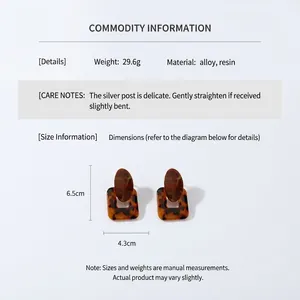 Detail showing oversized resin earrings with dimensions 6.5cm by 4.3cm and weight specs